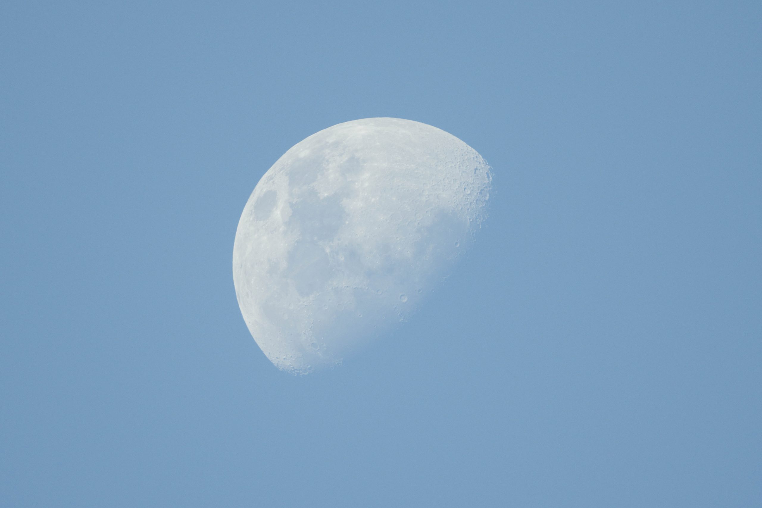 Half moon in blue sky