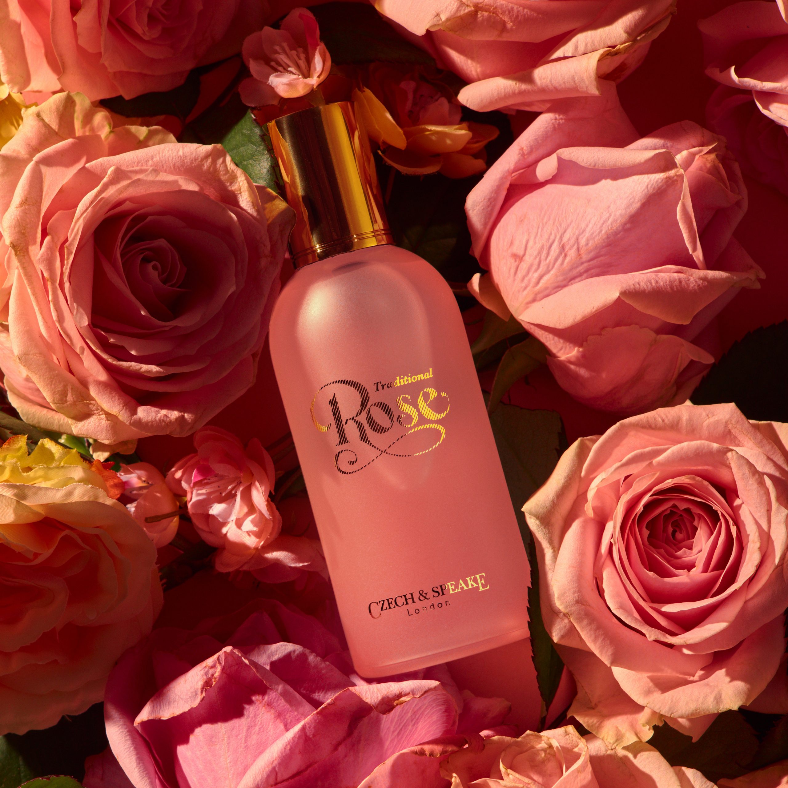 Rose fragrance 100ml lying on a bed roses in sunshine