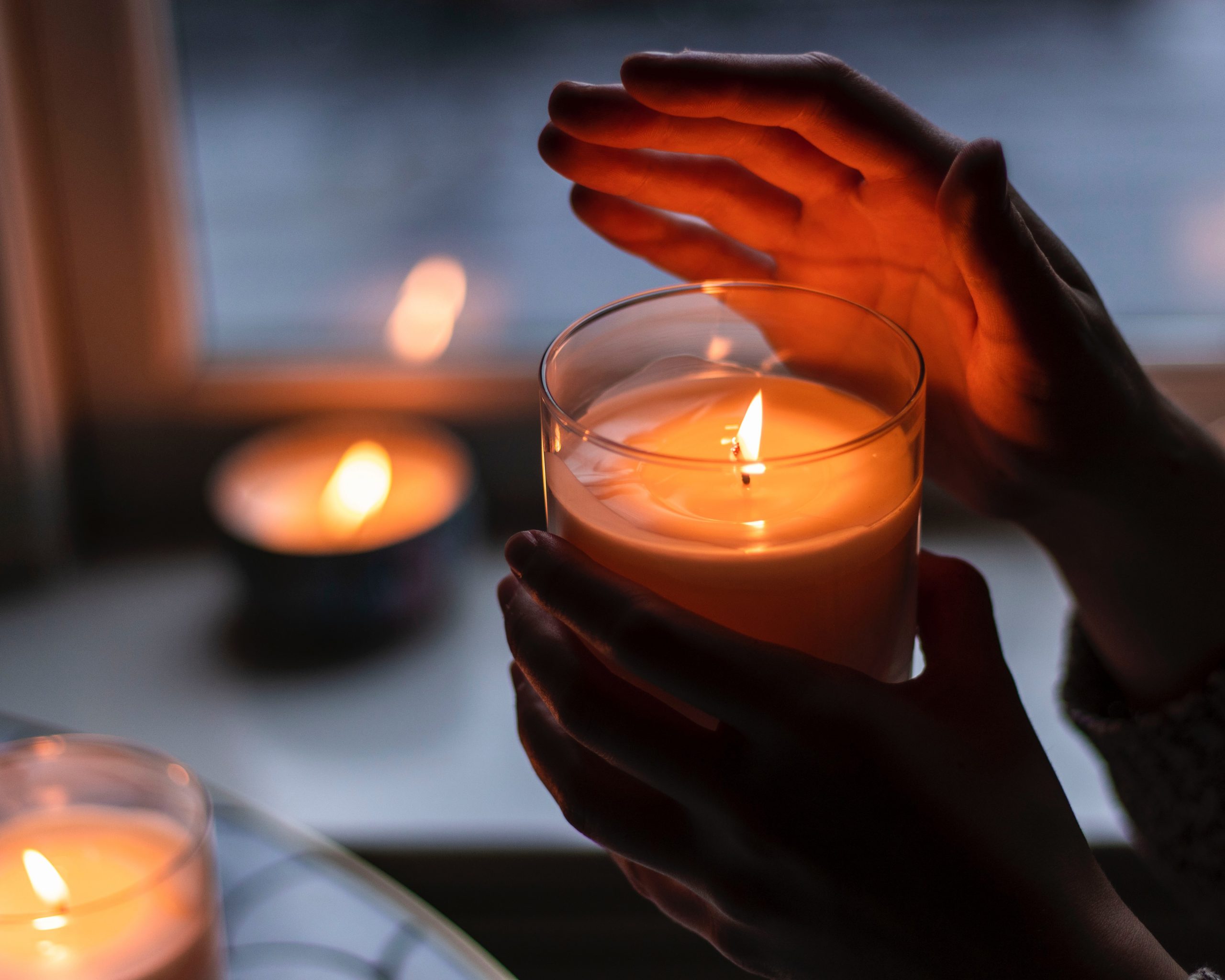 Hands holding candle