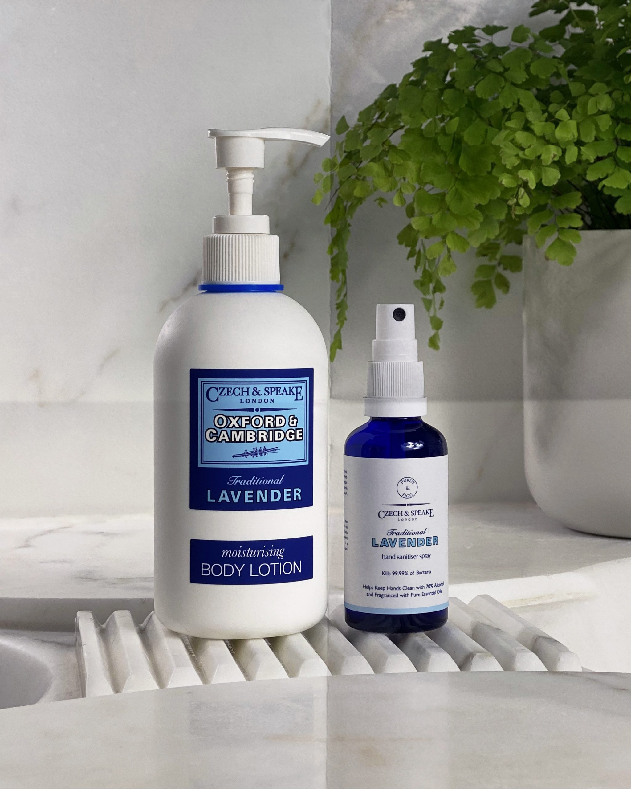 Oxford & Cambridge body lotion and lavender hand sanitiser on marble sink